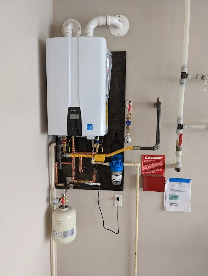 Professional plumber installing copper piping in a El Reno home